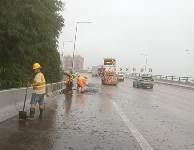 屯門公路水浸,工人忙於清理。 屯門公路水浸,工人忙於清理。