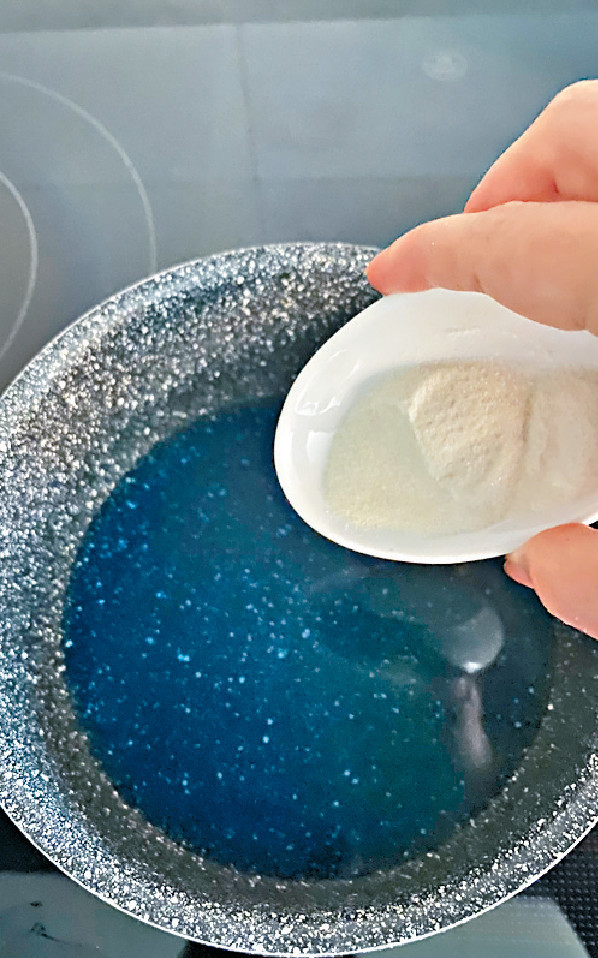 頂層：將蝶豆花粉茶袋及水煮出藍色，取走茶袋，待降溫；注入魚膠粉，拌勻；再加熱，加入糖拌勻。待回室溫。