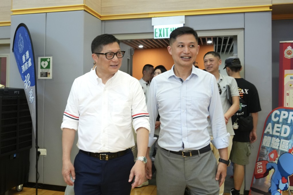 保安局局长邓炳强（左）参观消防及救护学院开放日。刘骏轩摄