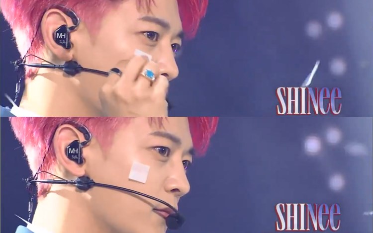 SHINee成员珉豪将飞舞的纸碎黐到脸上。