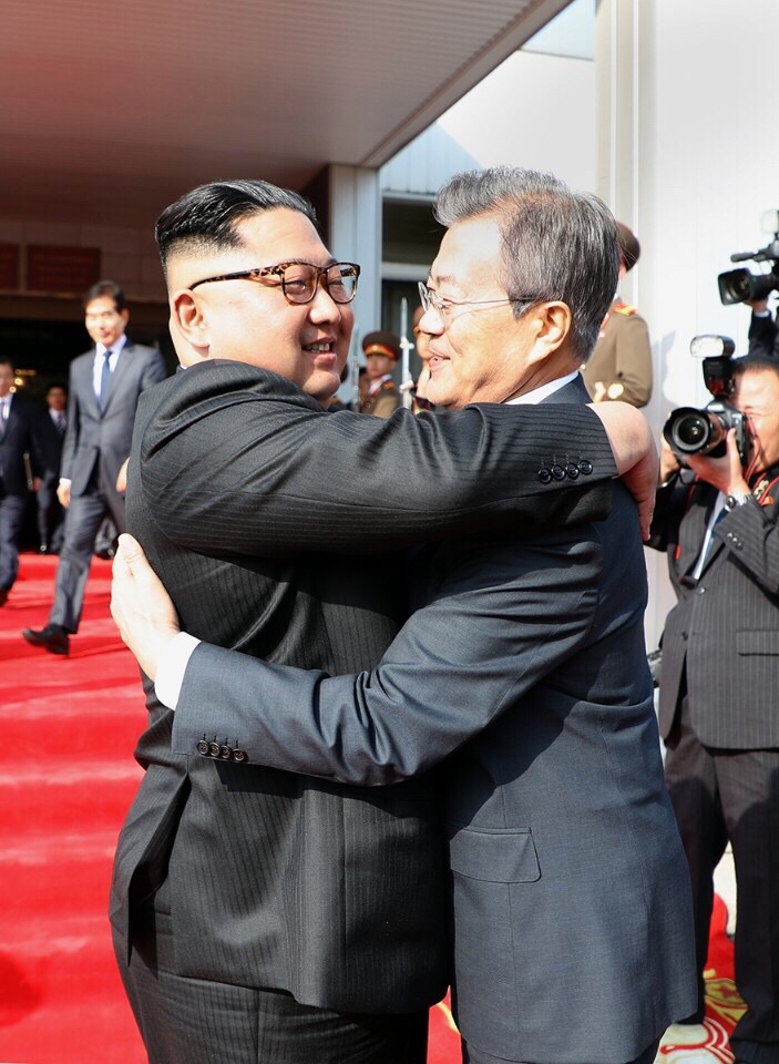金正恩与文在寅在“统一阁”门前拥抱。 新华社 金正恩与文在寅在“统一阁”门前拥抱。 新华社