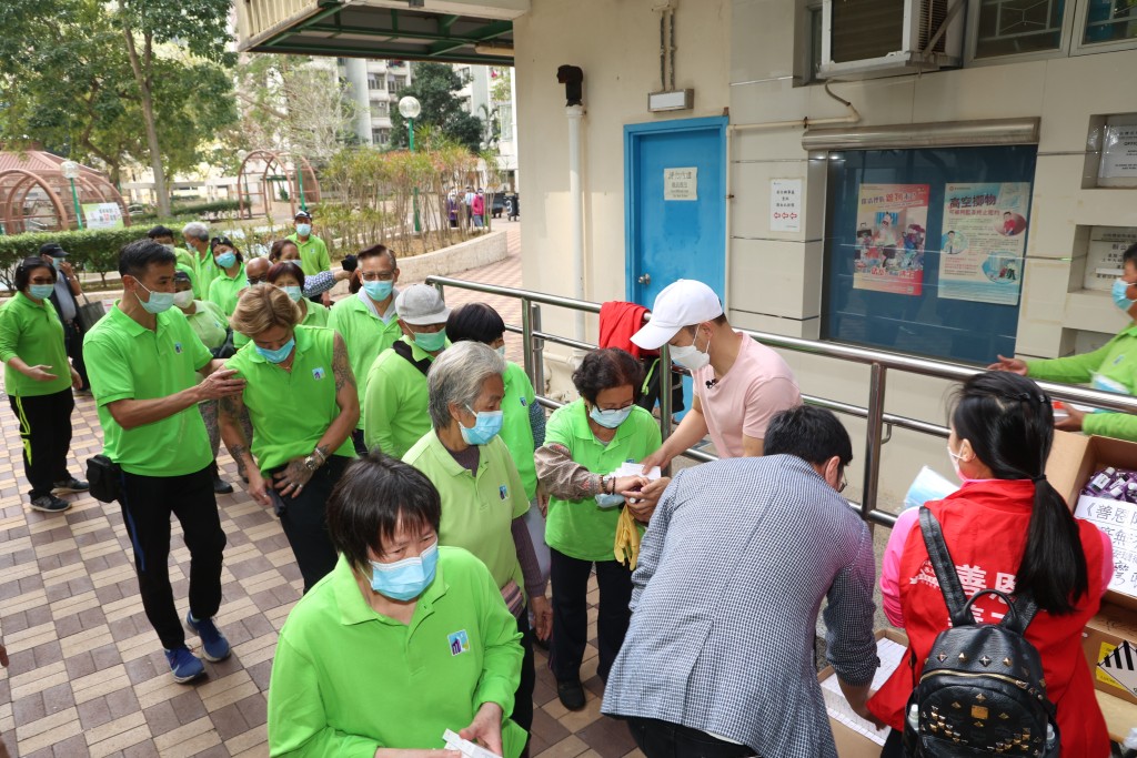 小西灣邨的清潔工人，在嘉年手上接過物資。