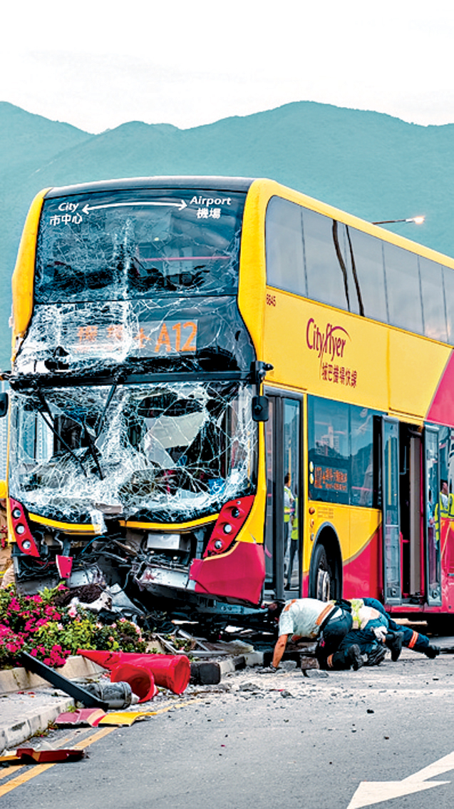 涉事城巴車頭擱在石壆上，擋風玻璃碎裂。