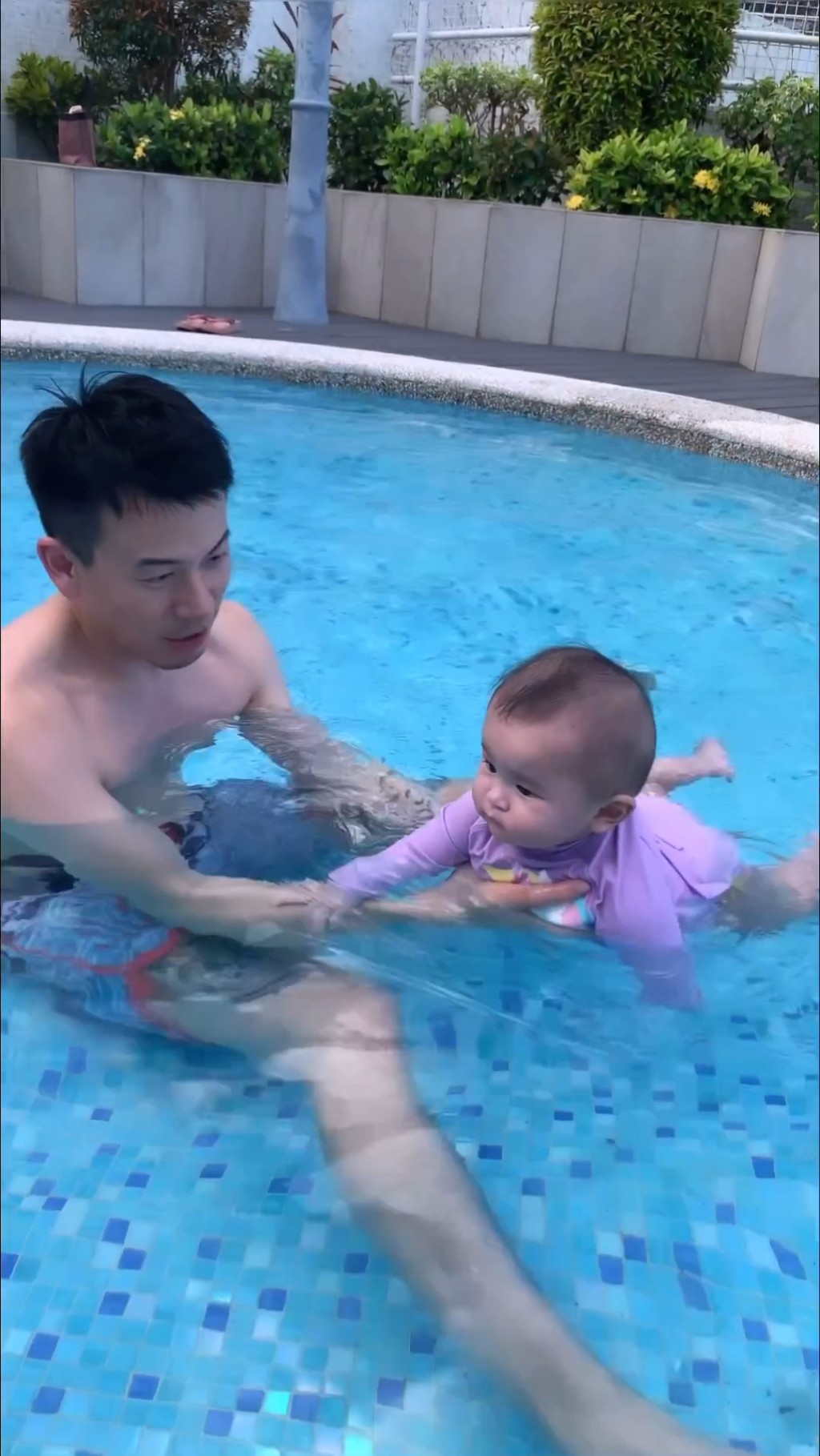 之後陳宇琛將女兒抱在手中，讓她浮在水面。