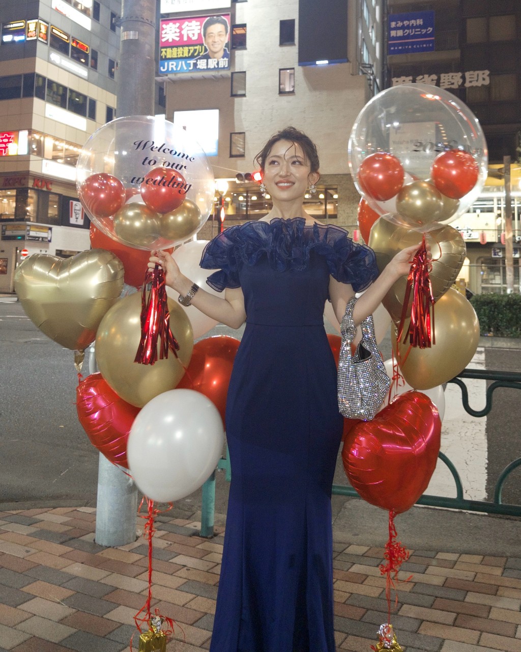 婚宴派對結束後，內田真由美拿著氣球在日本街頭留影。