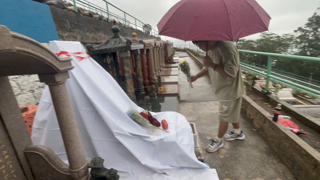 来自深圳的歌迷郝先生，专程到家驹的墓碑献花悼念。杨伟亨摄