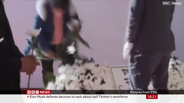 罹難者母親將花牌的花拔下。BBC新聞截圖