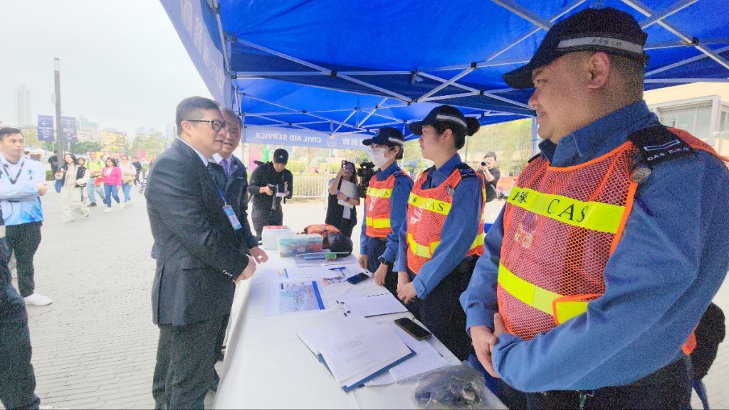 鄧炳強與民安隊人員交談。