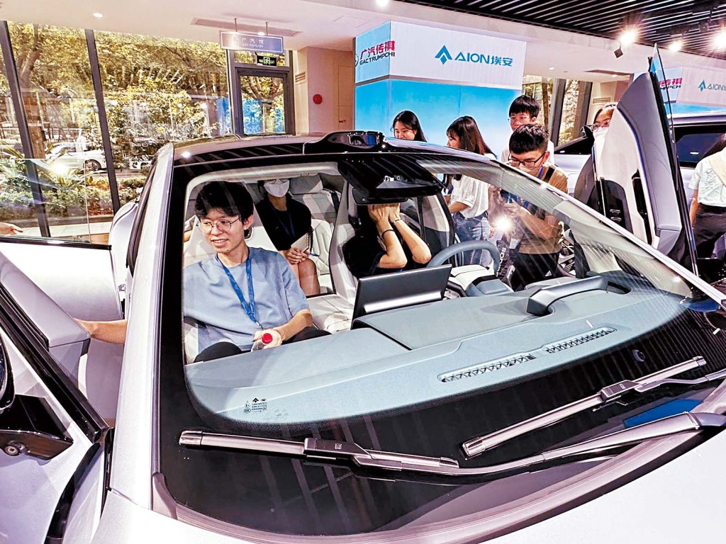 学生认识广州汽车工业发展史,坐上最新型号的车辆。