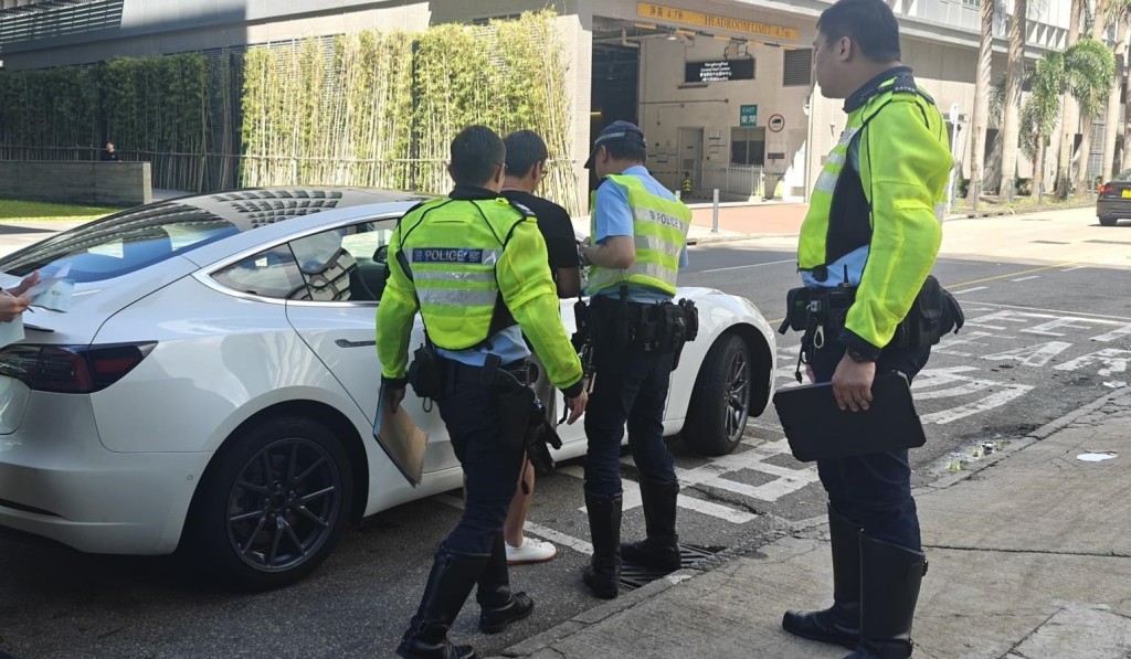 喬裝為乘客的警員，在九龍灣表露身份，拘捕兩名司機。警方圖片