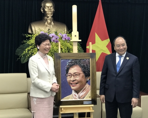 阮春福(右)向林鄭月娥贈送畫像。