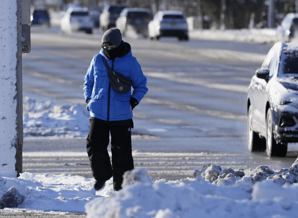芝加哥一名居民在布满雪的市面行走。美联社
