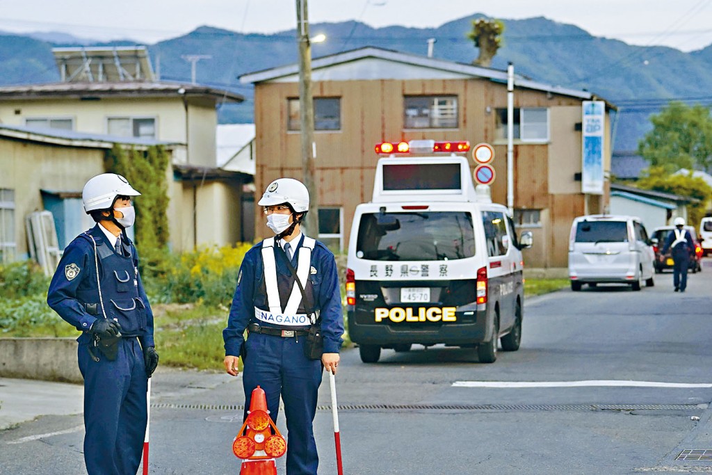 持獵槍男子犯案後躲入民宅，警察在街上戒備。　