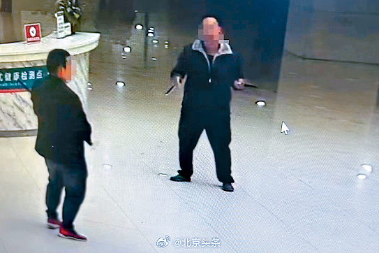 网传视频显示疑凶持刀与保安人员对峙。