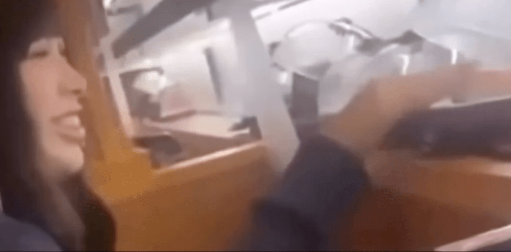 片段顯示，該名女子在藏壽司店內揭開輸送帶餐碟的透明蓋，用手觸碰壽司表面。X@Ryoukou_sub