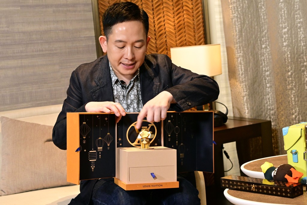 向展鹏指他十分喜欢LV送给VIP的礼物，其中一个就是他手上这个中秋节贺礼音乐盒连月饼。