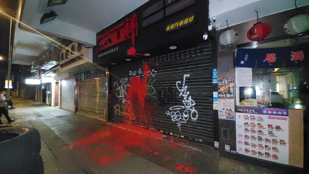 店铺大闸被淋上红油。