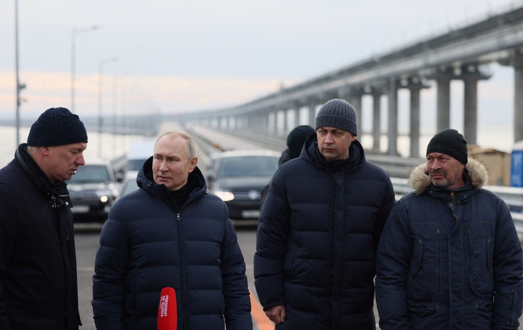 普京（左二）视察克里米亚大桥，副总理胡斯努林（左一）汇报大桥的维修工作进度。路透社