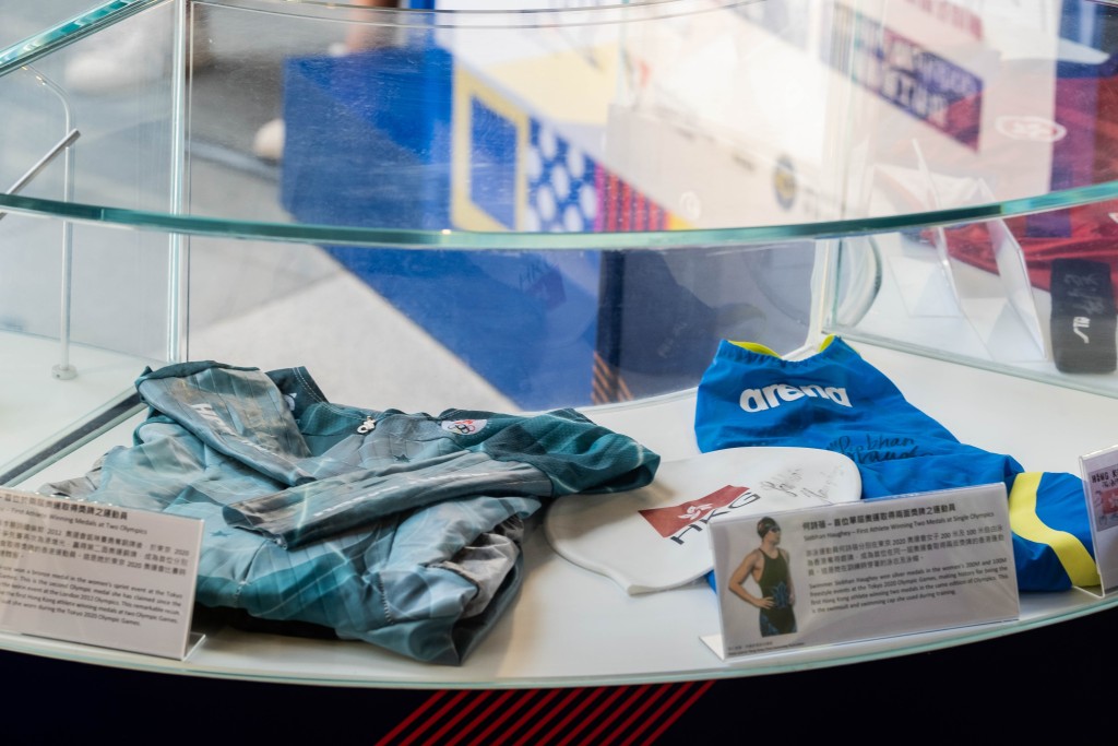 兩面游泳銀牌運動員何詩蓓在訓練時穿著的泳衣 及泳帽、香港游泳代表隊眾奧運選手之簽名卡、前單 車運動員李慧詩的戰衣。 公關圖片