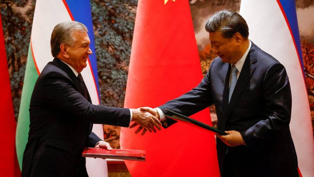 2023年5月18日，國家主席習近平和烏茲別克總統米爾濟約耶夫在西安舉行的中國-中亞峰會期間舉行的簽字儀式上握手。 路透社