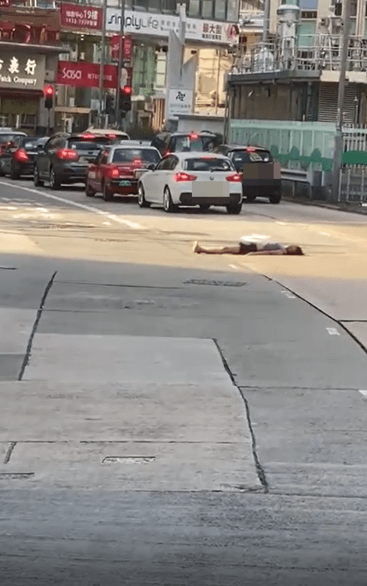 一名女子臥在荔枝角道馬路中間。影片截圖