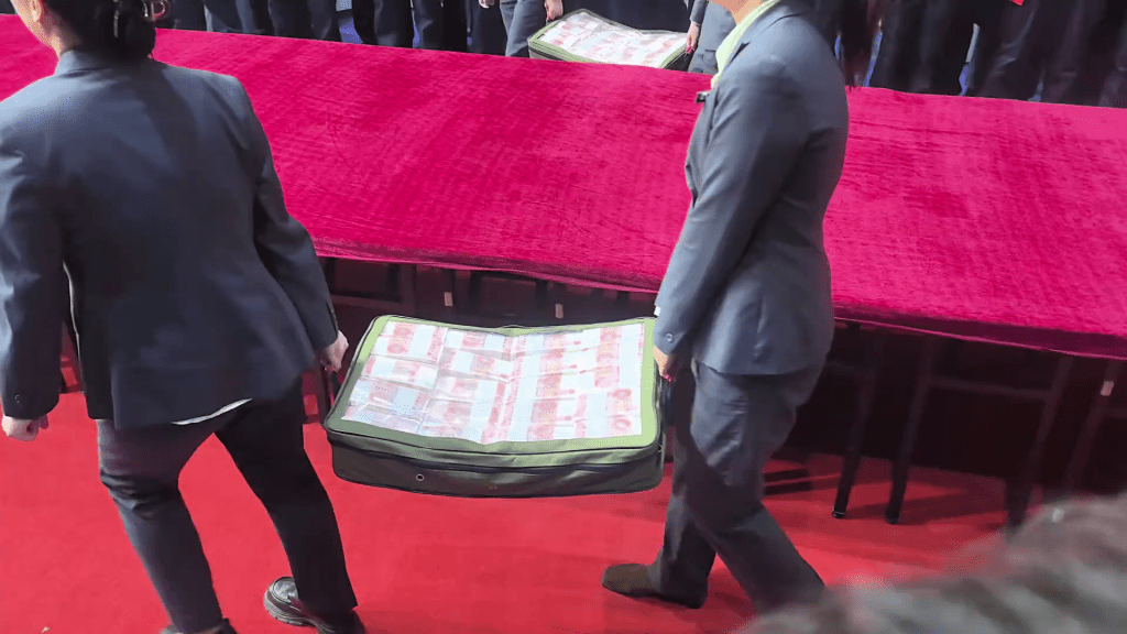 工作人员将现金运至现场。 工作人员将现金运至现场。