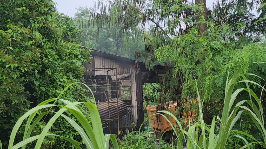 鐵皮屋外牆熏黑,消防開喉將火救熄。黎志偉攝 鐵皮屋外牆熏黑,消防開喉將火救熄。黎志偉攝