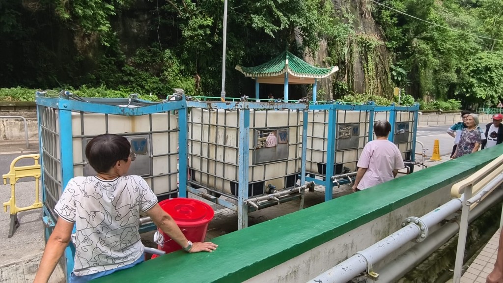 有居民在水箱旁等候水務署補給食水。黃文威攝 有居民在水箱旁等候水務署補給食水。黃文威攝