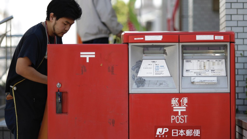 日本郵政工作人員正在收集郵件。 路透社