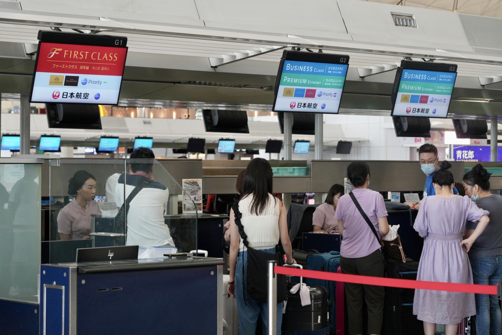 香港机场内仍有不少市民无惧地震，出发到日本旅游。欧乐年摄