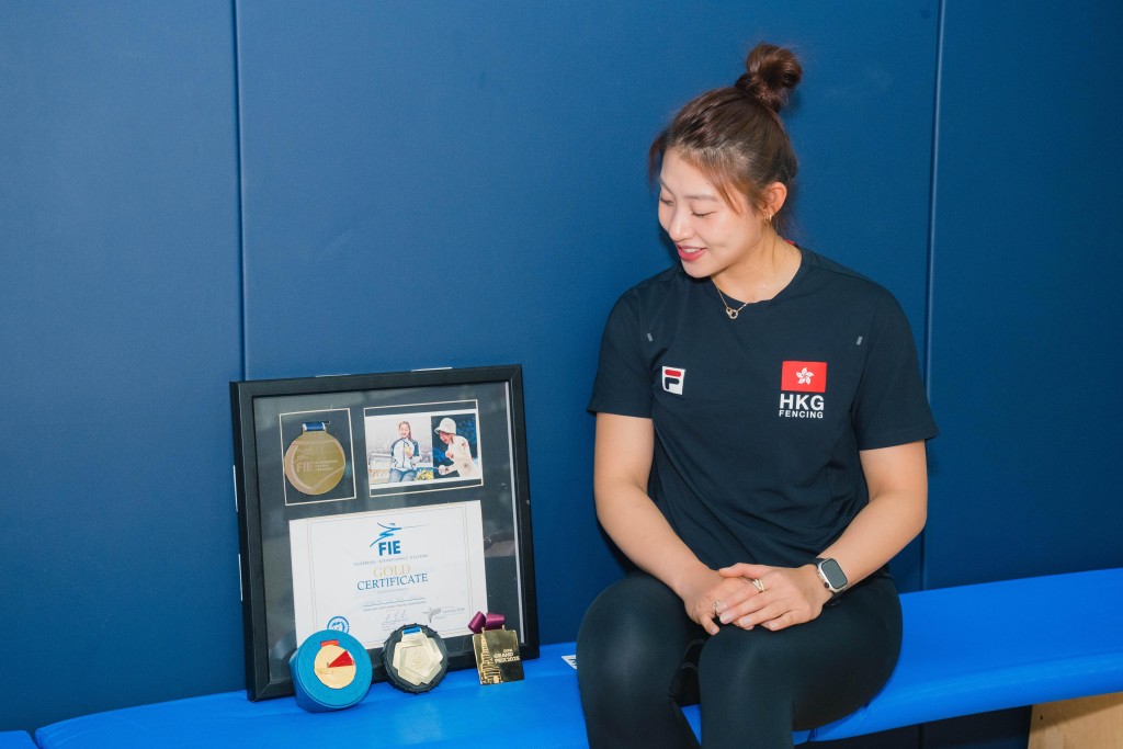 佘佘帶著微笑看著這些來之不易的獎牌。汪旭峰攝