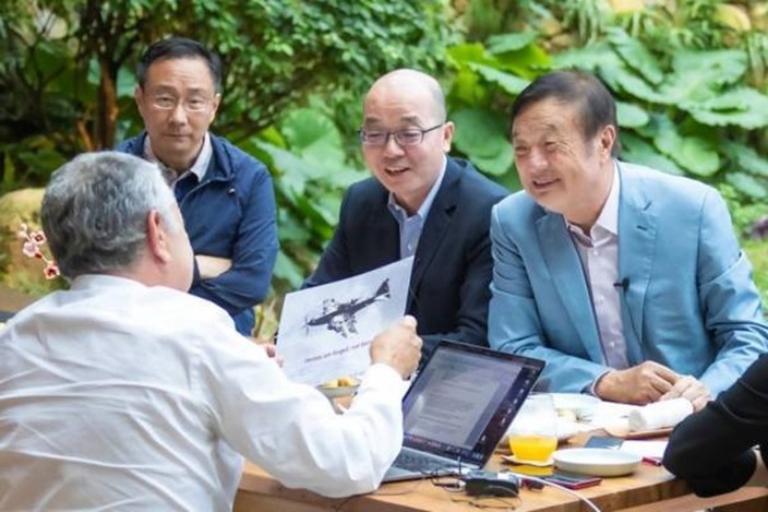 背向鏡頭的弗里德曼去年到深圳與任正非交流。(資料圖片)