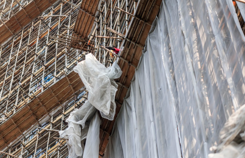 政府已對全港正進行大維修的樓宇外牆棚網完成採樣。資料圖片