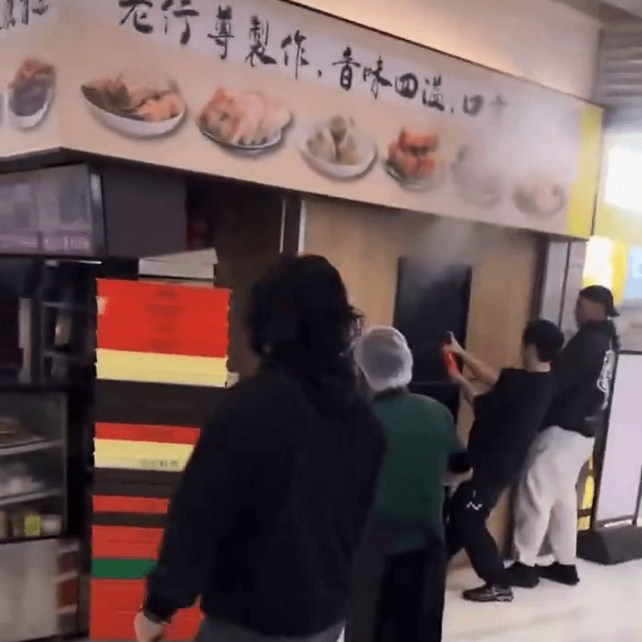 火舌涌出店舖，有男子持小型灭火筒试图救火。IG：mingkeeblacklamb