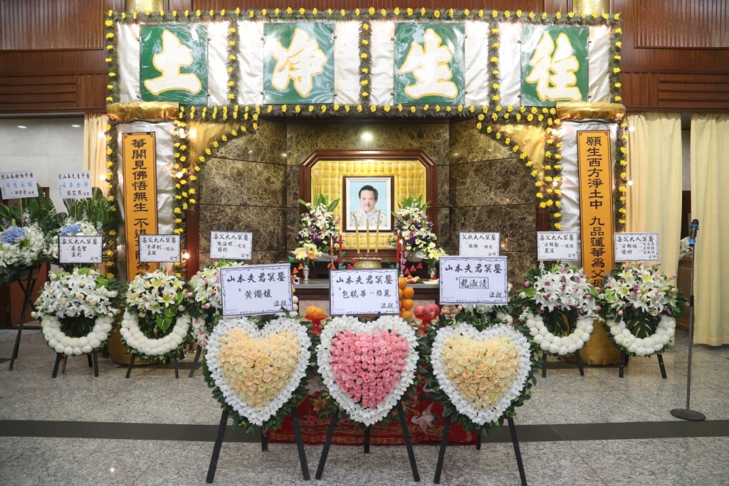 靈堂中央放置了遺孀包曉華及女兒劉雅麗的花牌。