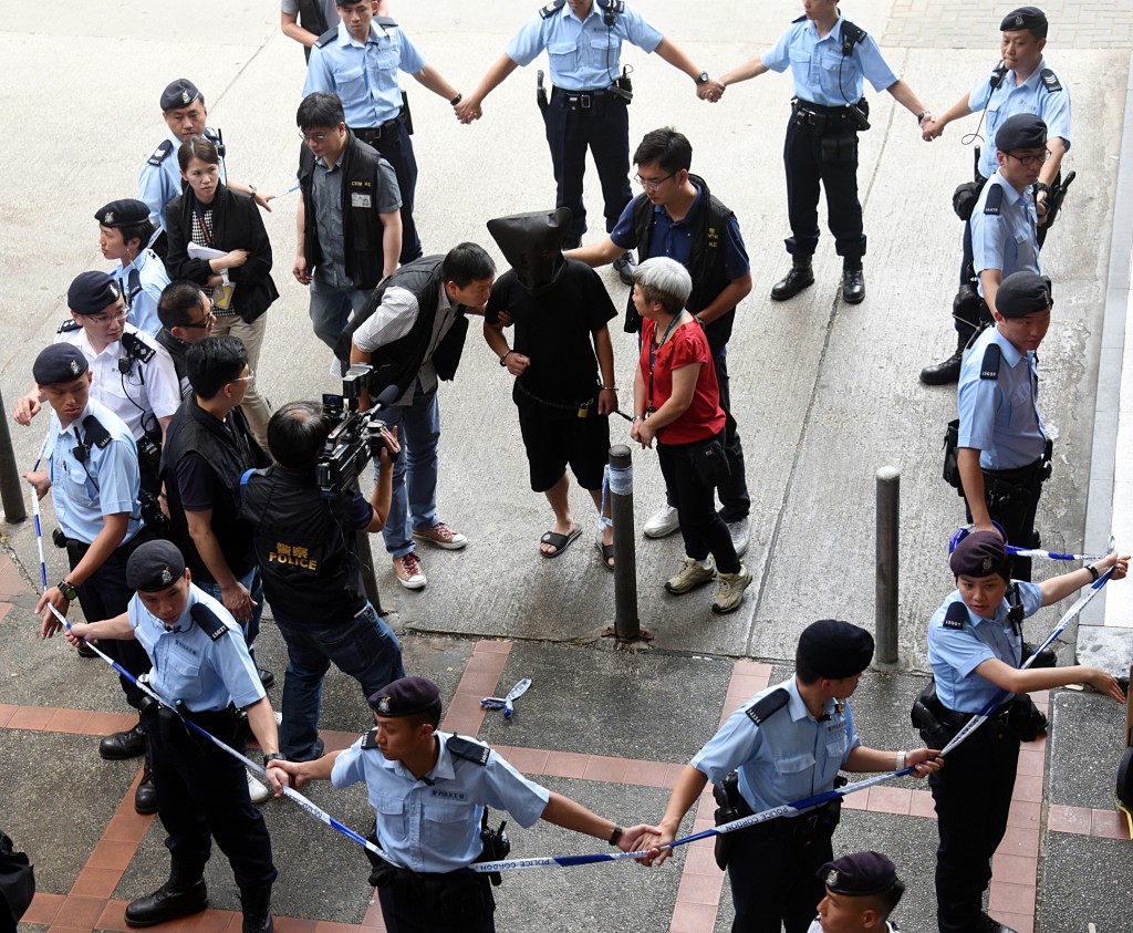 在港被捕的郑兴旺被押返现场重组案情。 在港被捕的郑兴旺被押返现场重组案情。