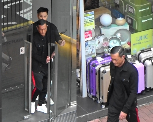 古仔在經理人Ronnie陪同下離開航空大廈。