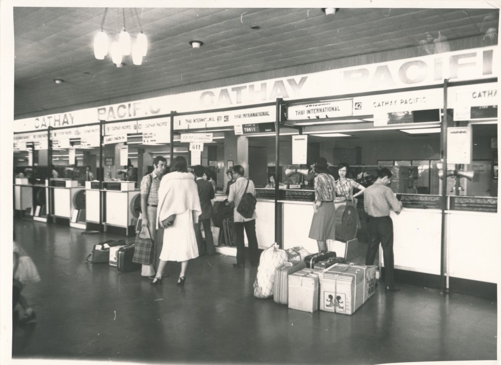 1975年旅客在啟德機場國泰櫃檯等候辦理登機及寄行李手續。資料圖片