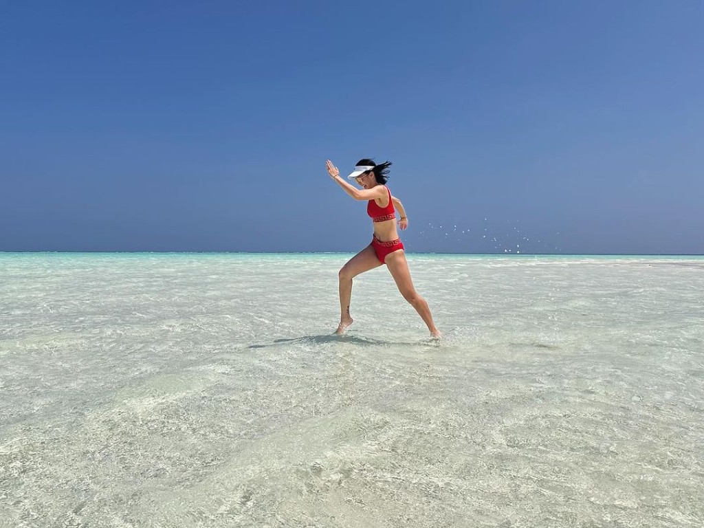 黄心颖最近去了马尔代夫度假，她穿上火辣辣红色比坚尼在沙滩上狂奔。