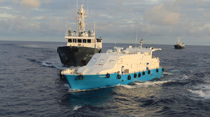 菲方用改裝的鐵甲快船（藍白色）企圖衝過中方對仁愛礁的封鎖。
