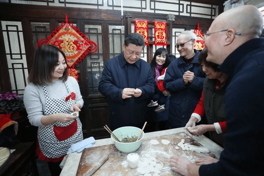 2019，习近平在北京前门东区草厂四条胡同，同朱茂锦一家人包饺子。新华社