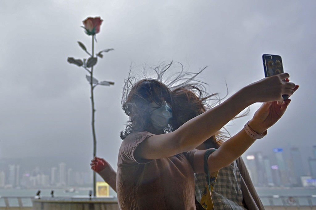 市民冒狂风大雨到尖沙嘴海旁，自拍留念。