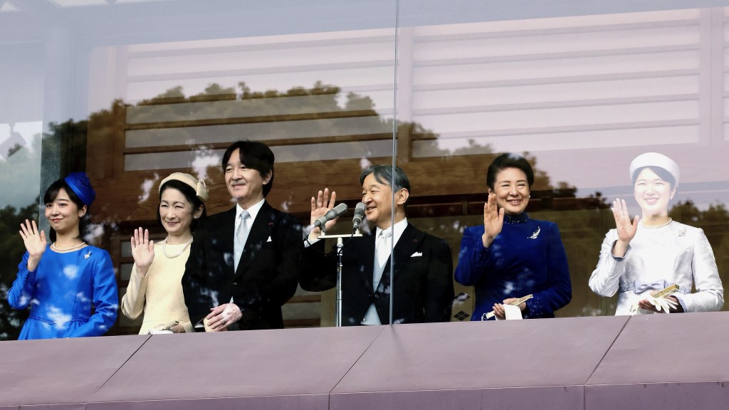 64岁生日的日皇德仁（右三）在其他皇室成员陪同下接受民众祝贺。 美联社
