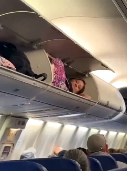 美國廉航西南航空有女乘客爬上行李架當做卧鋪。