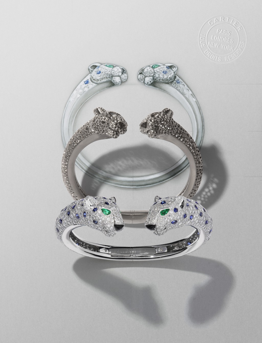 美洲豹系列珠寶的設計，由繪圖到每個製作工序都可見其細緻，像這造型立體的美洲豹白金鑲嵌祖母綠、藍寶石、縞瑪瑙及鑽石手鐲，兩顆豹頭互相對視的設計，栩栩如生。