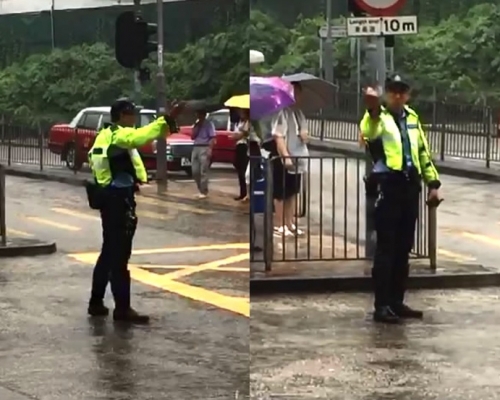 兩名交通警冒雨指揮交通約半小時。影片截圖