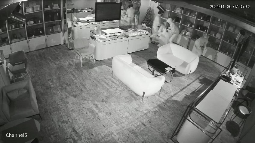 3名贼人甫入店后，随即砸烂大门旁边的玻璃饰柜。片段截图