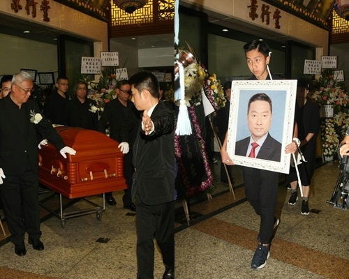 曾守明出殯,兒子捧亡父遺照。