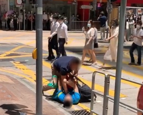 兩男在地上扭作一團，市民路過只是旁觀。香港突發事故報料區FB