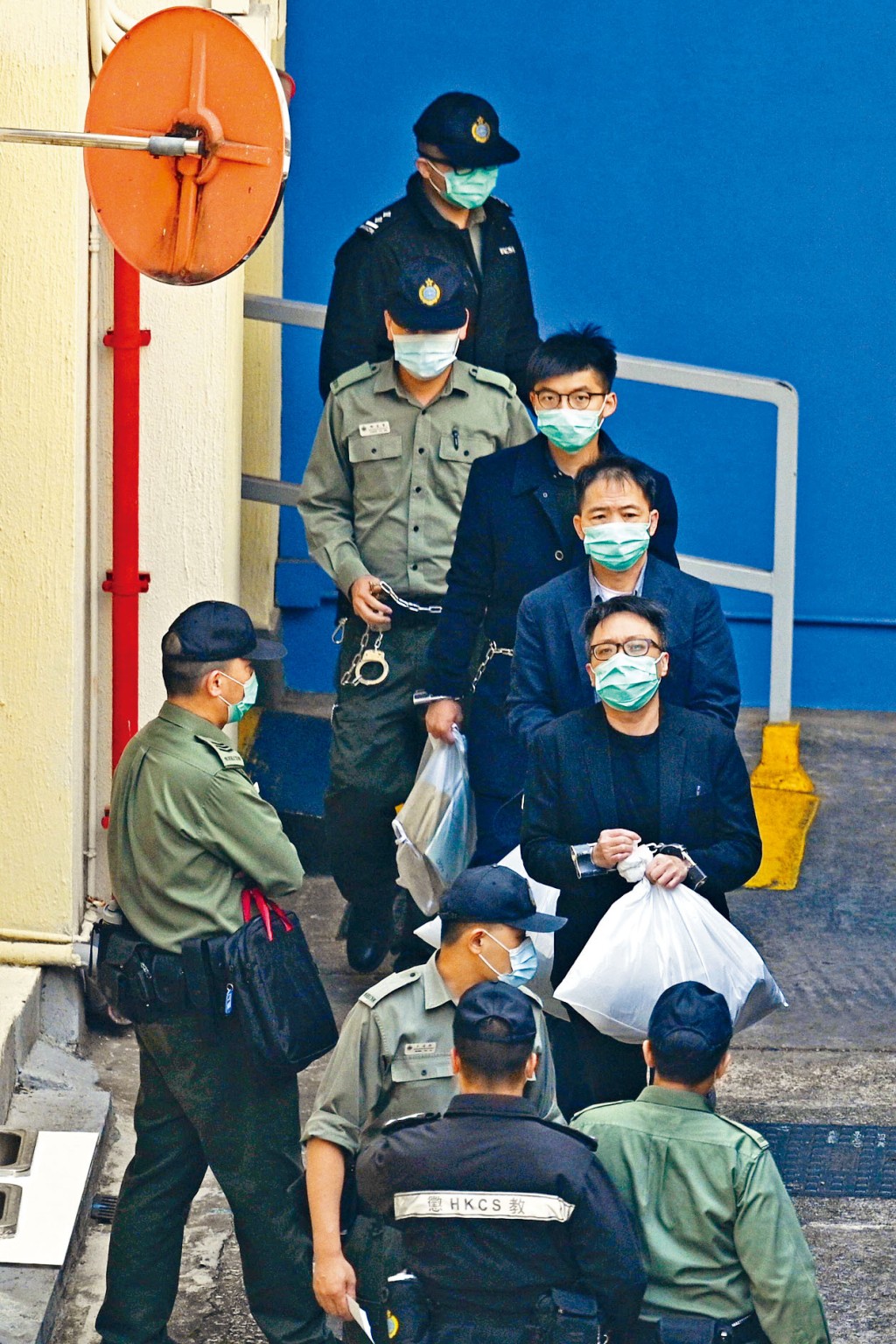 (由後至前)被告黃之鋒、胡志偉及譚得志昨由茘枝角收柙所解往西九龍法院。